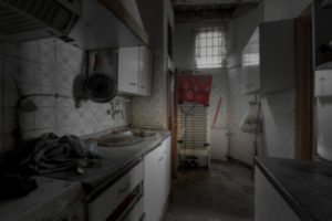 Interior of an apartment with abandoned walls, ceilings and floors in the center of a European city interior kitchen without people and with a dark atmosphere Interior of an apartment with abandoned walls, ceilings and floors in the center of a European city interior kitchen without people and with a dark atmosphere